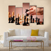 Male hand moving the black chess knight multi panel canvas wall art