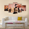 Male hand moving the black chess knight multi panel canvas wall art