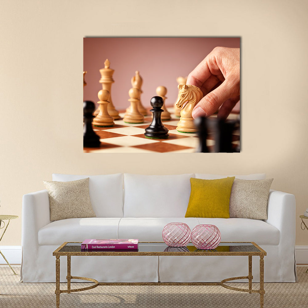 Male hand moving the white chess knight multi panel canvas wall art