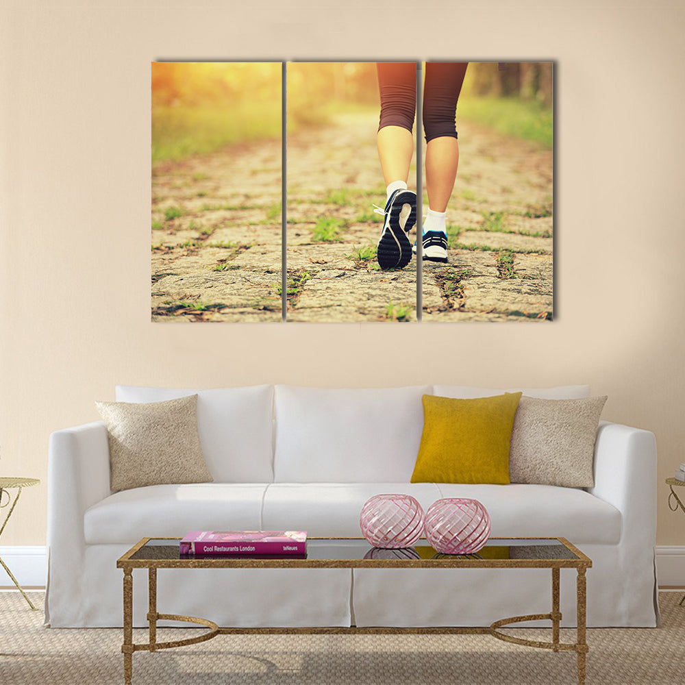 Young fitness woman legs walking on forest trail, Multi panel canvas wall art