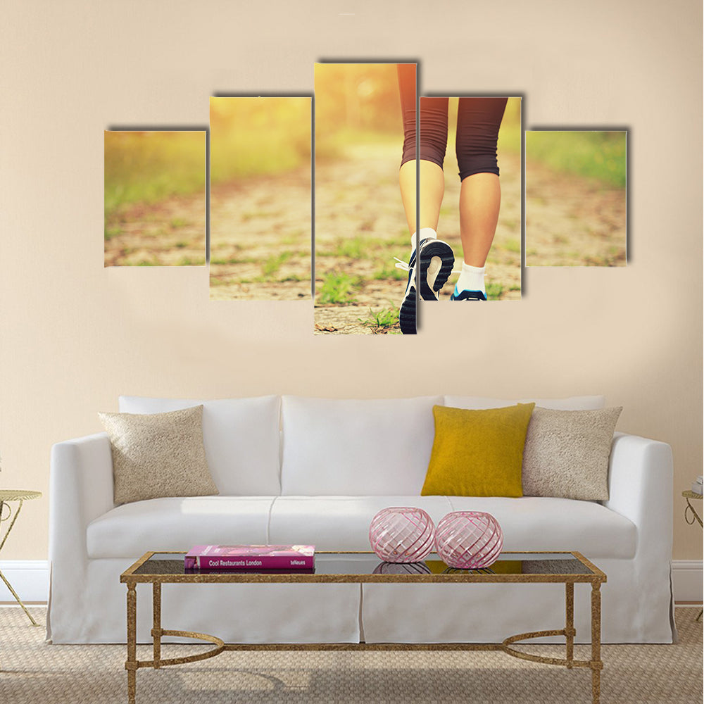 Young fitness woman legs walking on forest trail, Multi panel canvas wall art