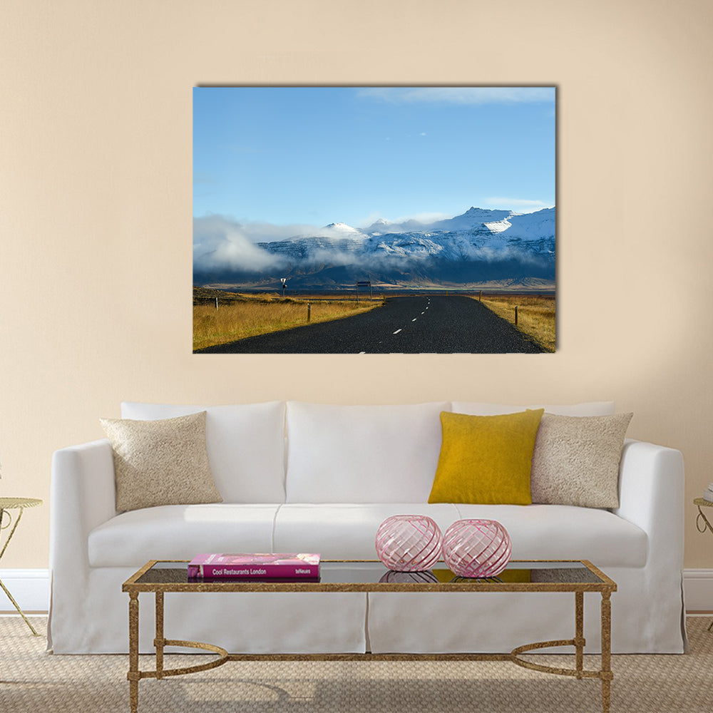 Empty road leading to snow covered mountains multi panel canvas wall art