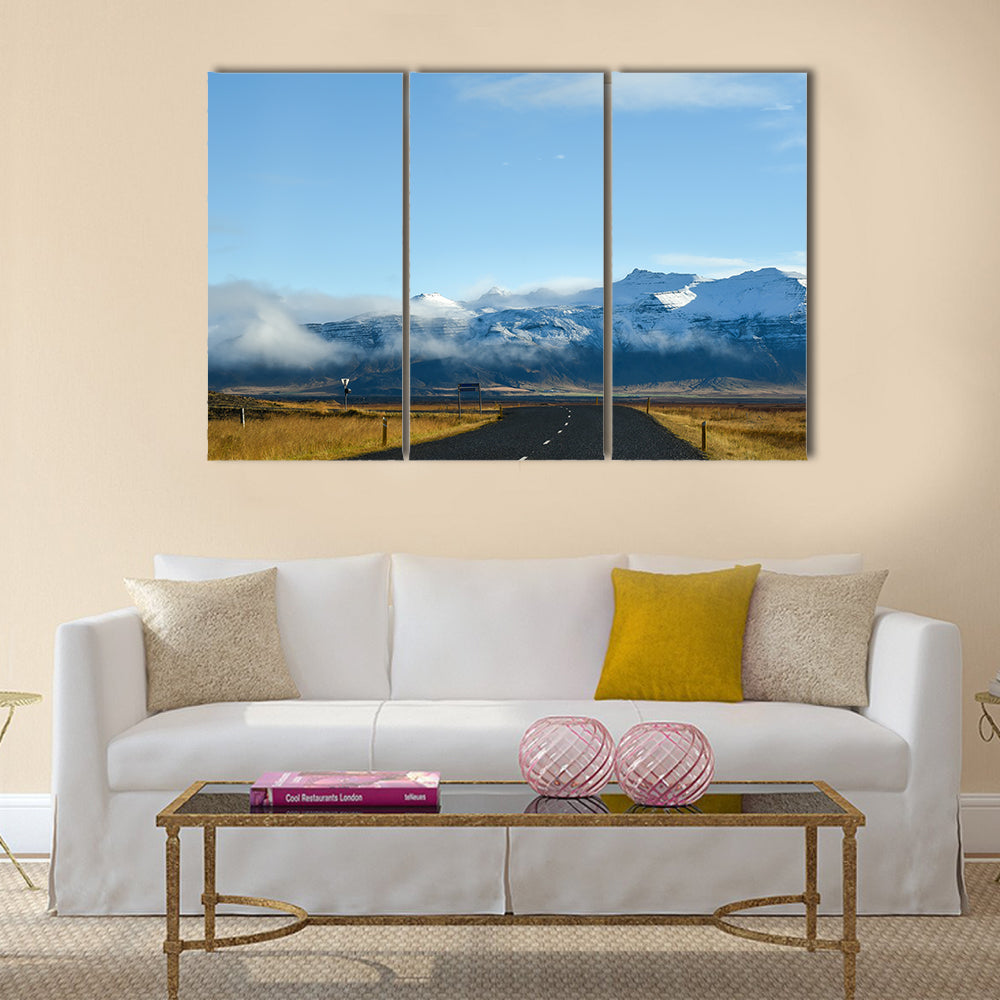 Empty road leading to snow covered mountains multi panel canvas wall art