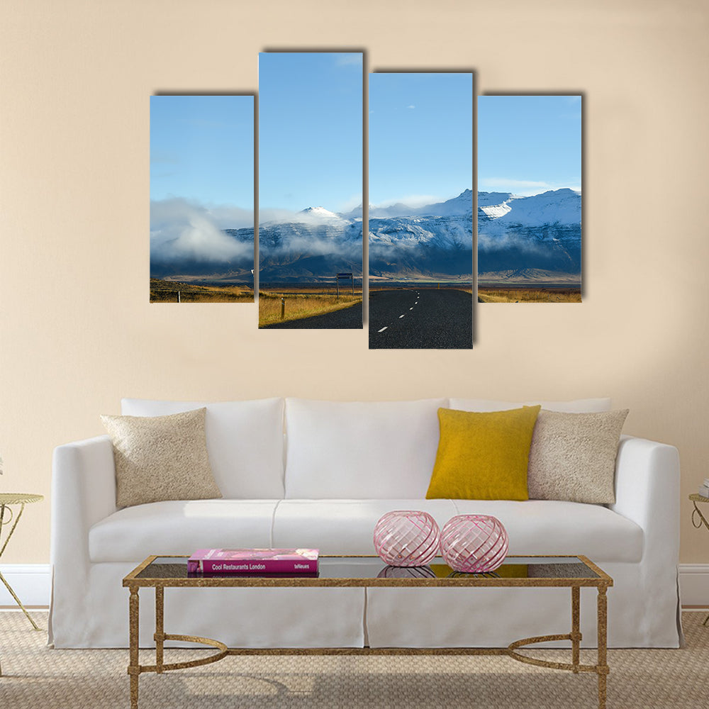 Empty road leading to snow covered mountains multi panel canvas wall art
