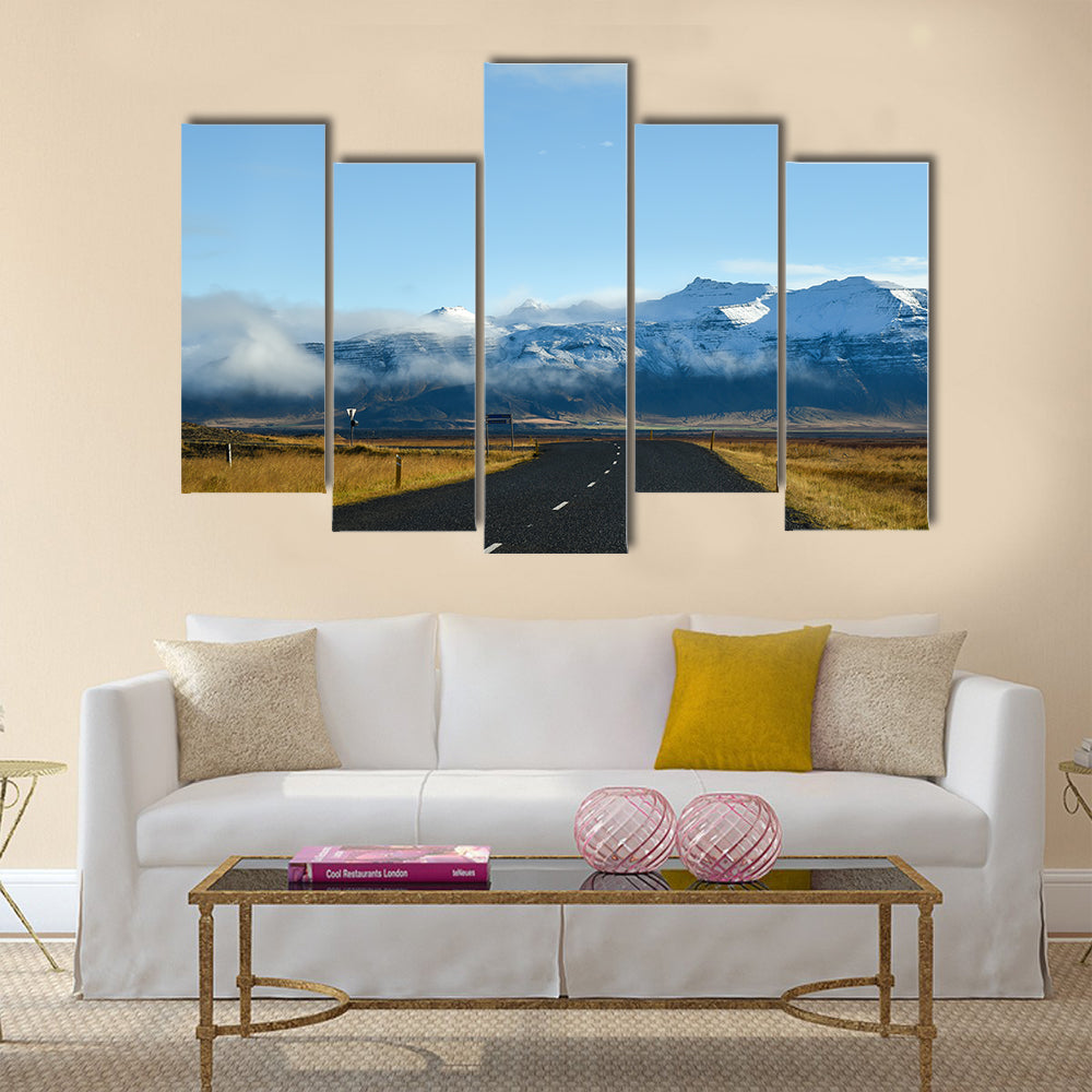Empty road leading to snow covered mountains multi panel canvas wall art