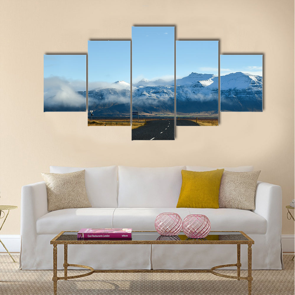 Empty road leading to snow covered mountains multi panel canvas wall art