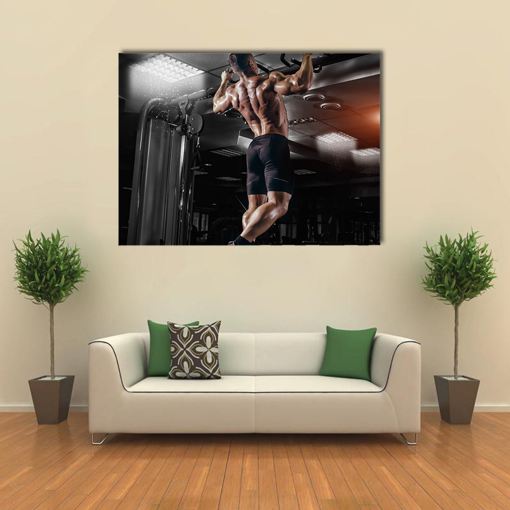 Muscle athlete man in gym making elevations Multi panel canvas wall art