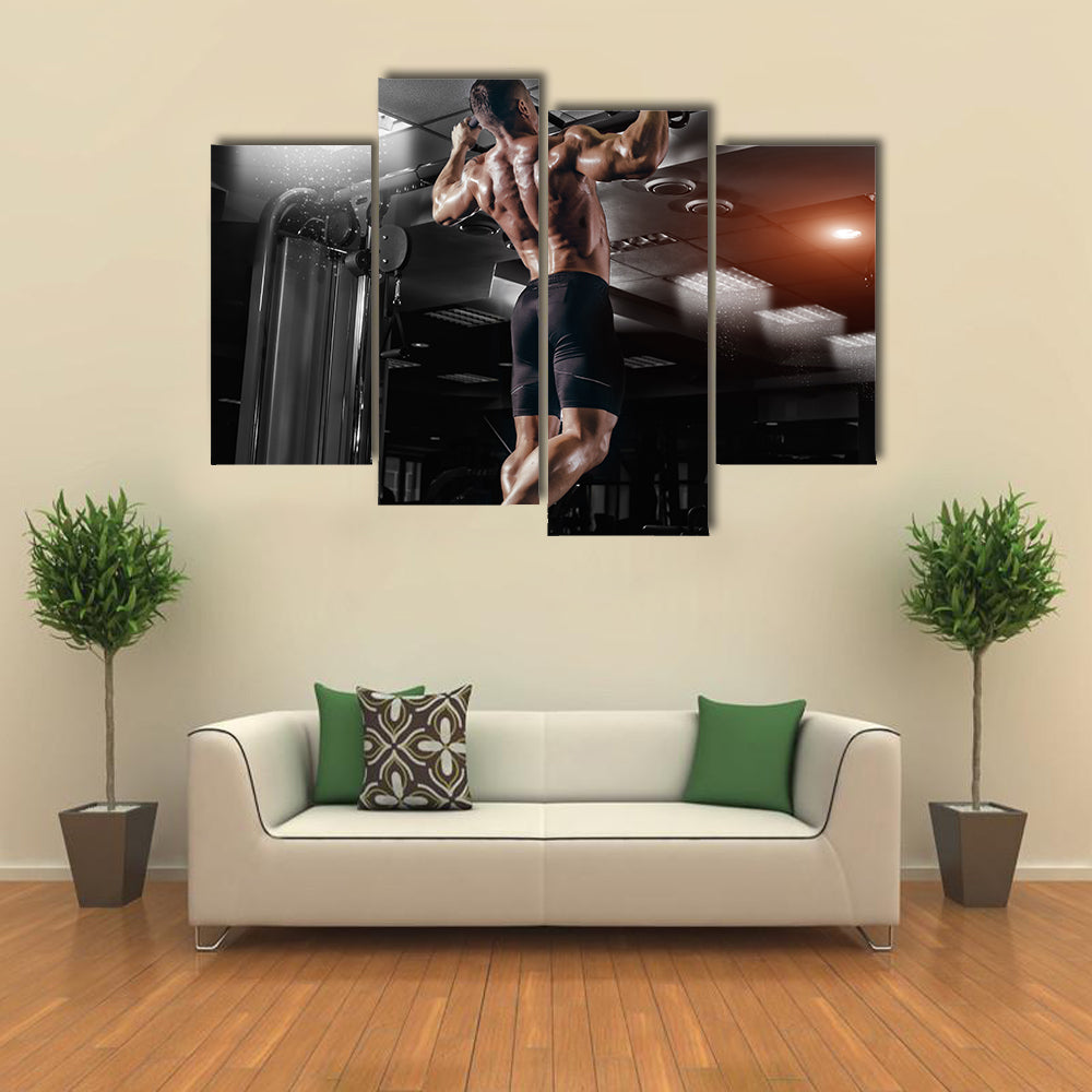 Muscle athlete man in gym making elevations Multi panel canvas wall art