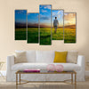 One man and field of spring grass and sunset, Multi panel canvas wall art