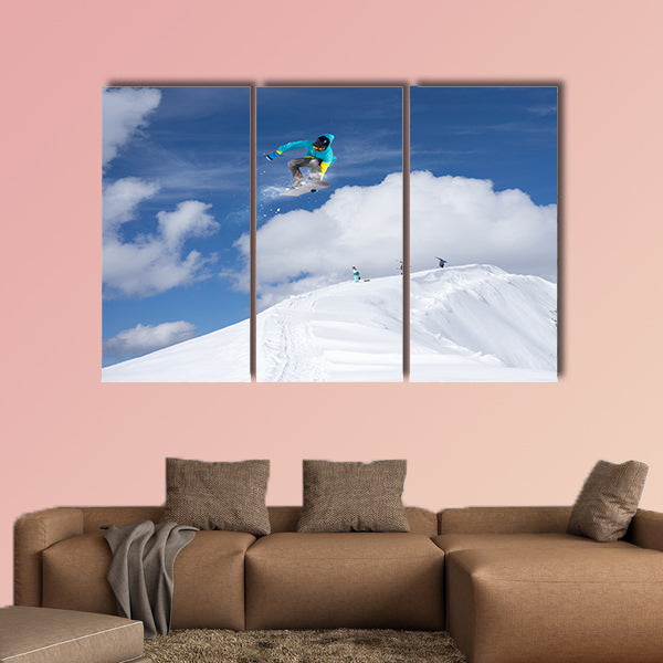 Flying snowboarder on mountains. Extreme winter sport Multi panel canvas wall art