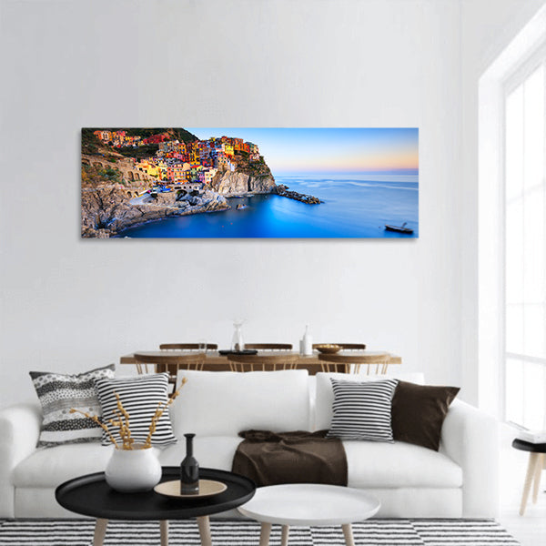 Manarola village on cliff rocks and sea at sunset panoramic canvas wall art
