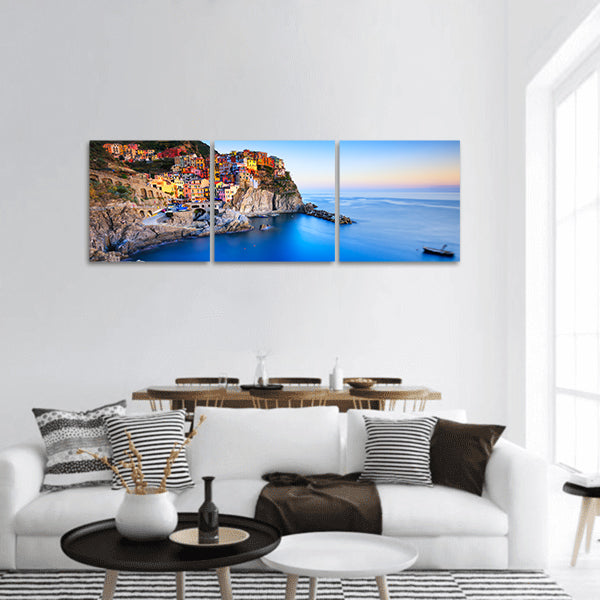 Manarola village on cliff rocks and sea at sunset panoramic canvas wall art