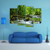 A Mountain stream in a tropical rain forest multi panel canvas wall art