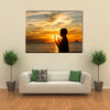 A Boy Praying With Deep Attention On A Beach In Front Of The God In The Evening Multi Panel Canvas Wall Art