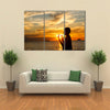 A Boy Praying With Deep Attention On A Beach In Front Of The God In The Evening Multi Panel Canvas Wall Art