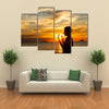 A Boy Praying With Deep Attention On A Beach In Front Of The God In The Evening Multi Panel Canvas Wall Art