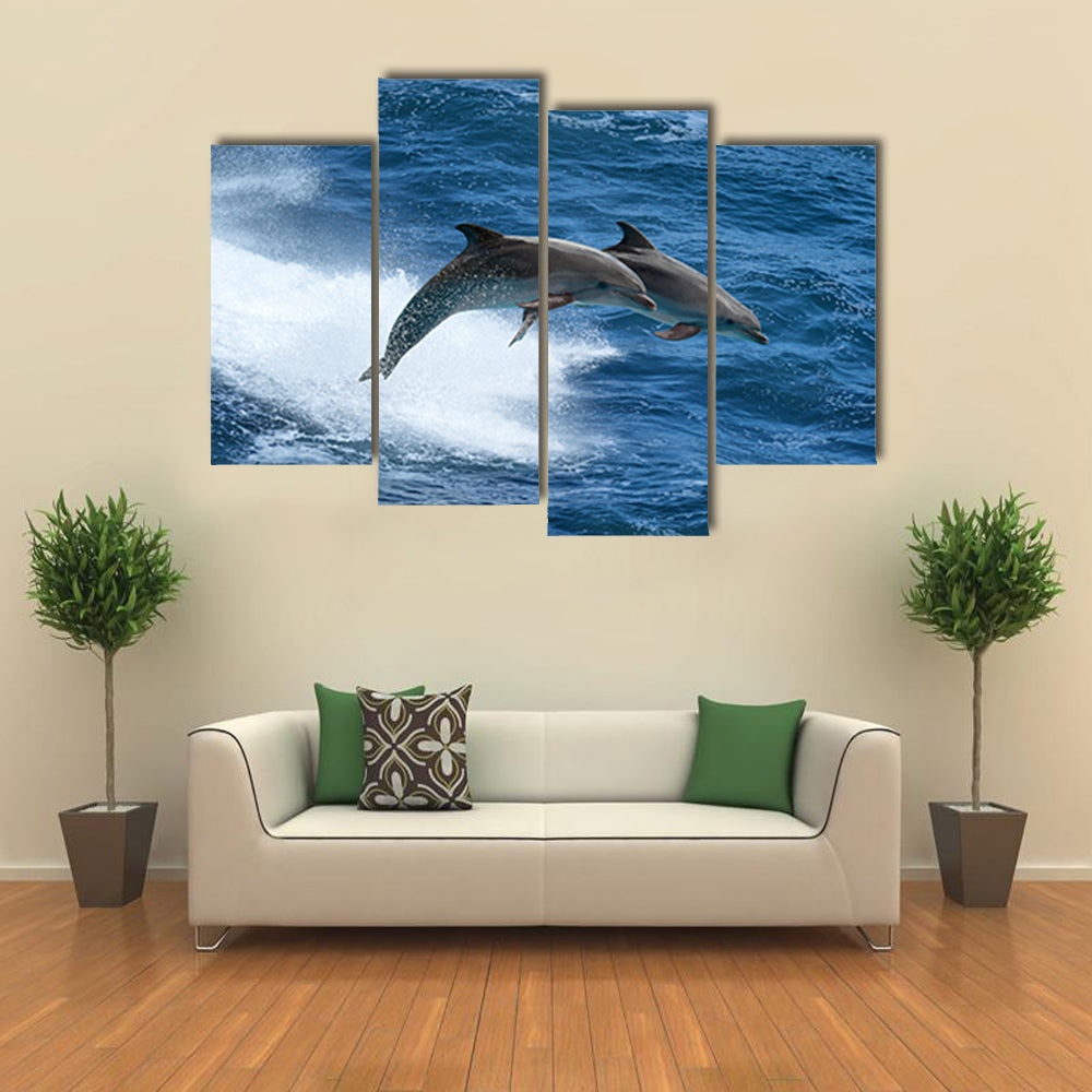 Wild nature background - two jumping dolphins in stormy sea Multi Panel Canvas Wall Art