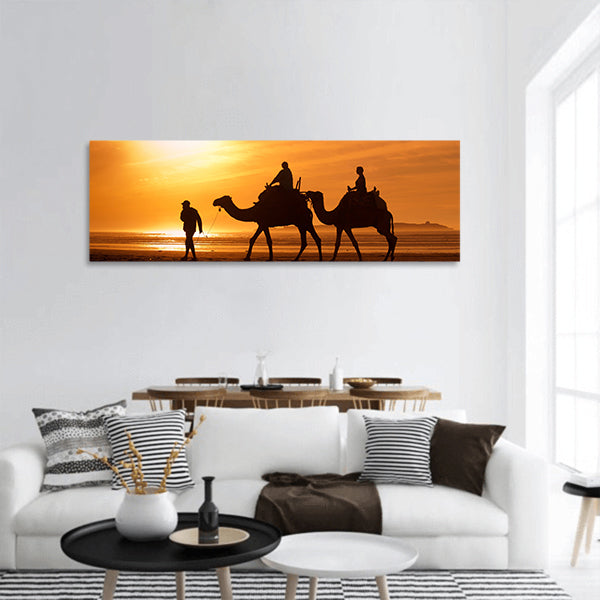 Silhouettes of camels at sunset Panoramic Canvas Wall Art