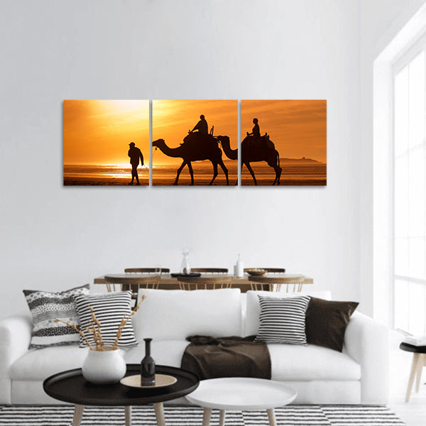 Silhouettes of camels at sunset Panoramic Canvas Wall Art