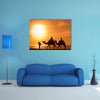 Silhouettes of camels at sunset multi panel canvas wall art