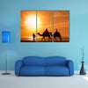 Silhouettes of camels at sunset multi panel canvas wall art