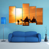 Silhouettes of camels at sunset multi panel canvas wall art