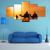 Silhouettes of camels at sunset multi panel canvas wall art