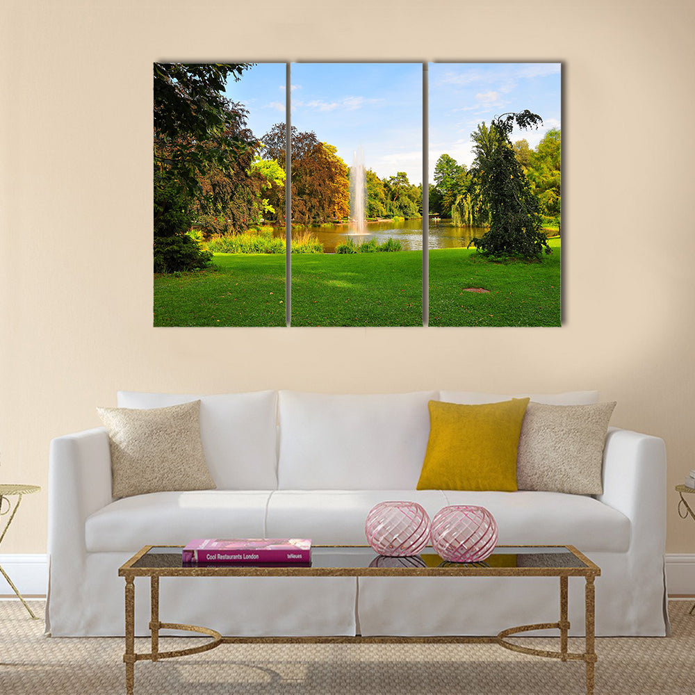 A shot of a fountain in Orangerie Park, Strasbourg, Alsace, France Multi Panel Canvas Wall Art