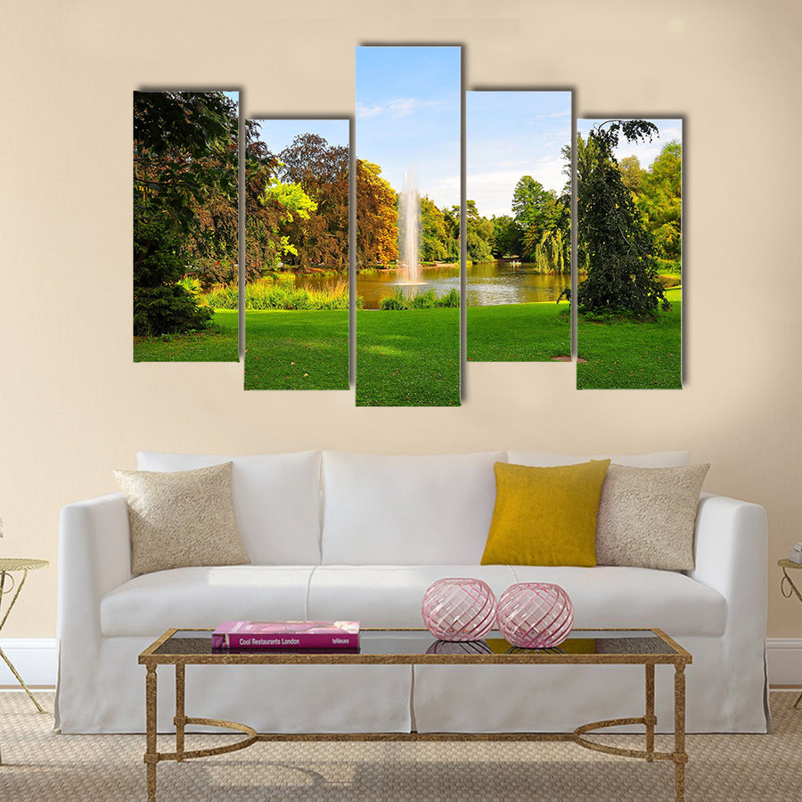 A shot of a fountain in Orangerie Park, Strasbourg, Alsace, France Multi Panel Canvas Wall Art
