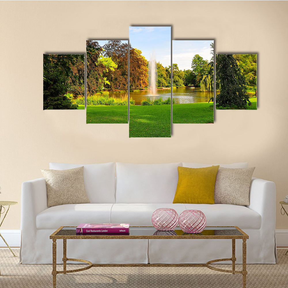 A shot of a fountain in Orangerie Park, Strasbourg, Alsace, France Multi Panel Canvas Wall Art