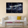 Lighthouse illuminated at night Multi Panel Canvas Wall Art