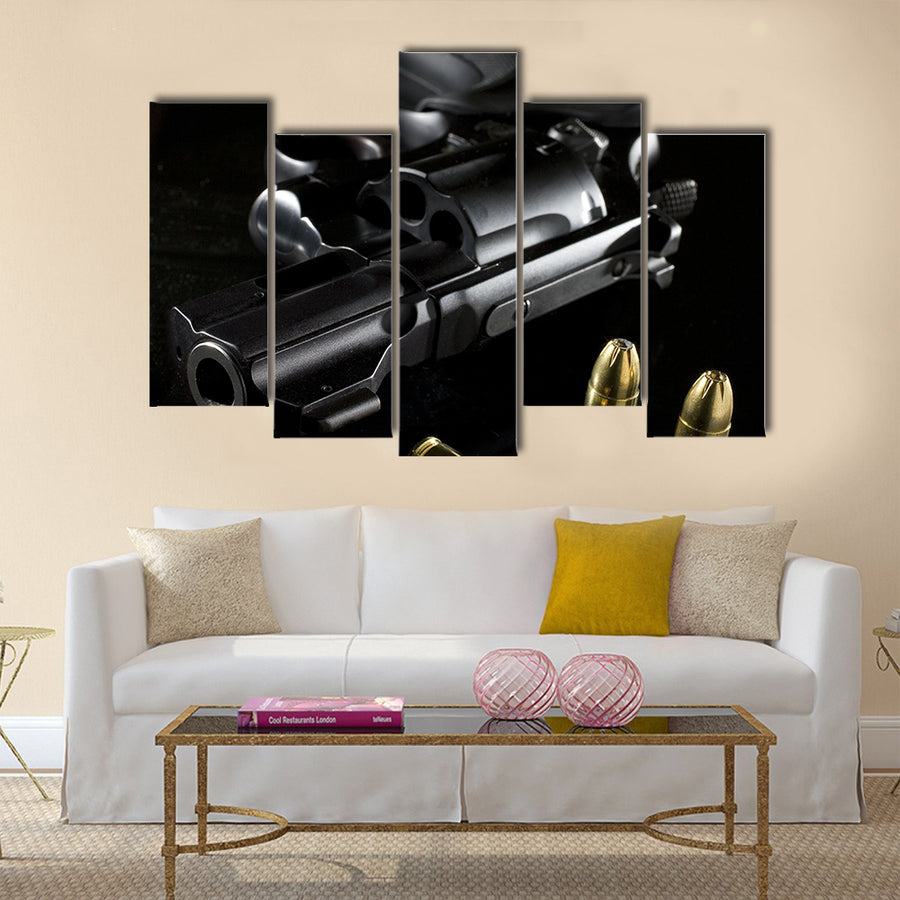 black revolver that is on a glass table  multi panel canvas wall art