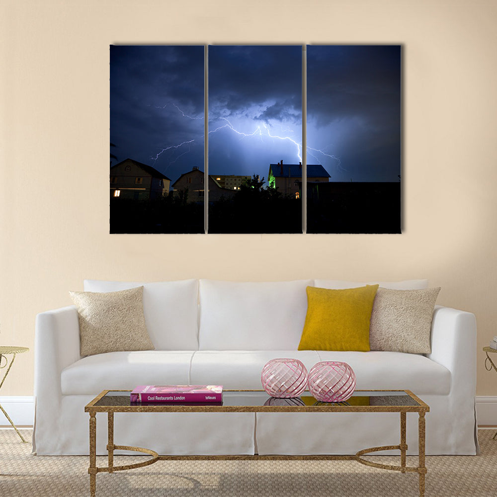 Lightning in the cloudy storm sky over village Multi Panel Canvas Wall Art