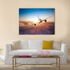 Commercial airplane flying above clouds in dramatic sunset light multi panel canvas wall art