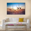 Commercial airplane flying above clouds in dramatic sunset light multi panel canvas wall art