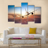 Commercial airplane flying above clouds in dramatic sunset light multi panel canvas wall art