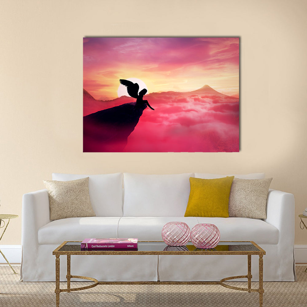 Silhouette of a lonely fallen angel with long wings standing on a cliff against a paradise sunset Multi Panel Canvas Wall Art