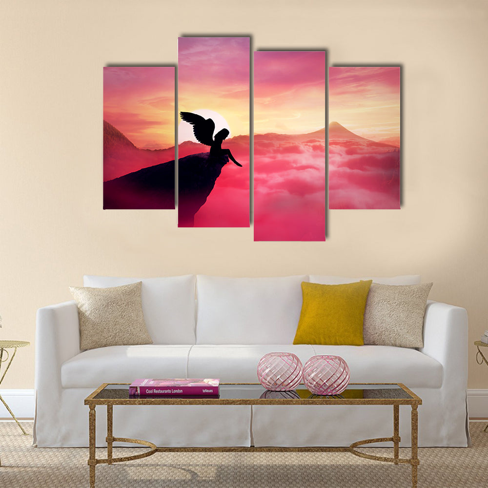 Silhouette of a lonely fallen angel with long wings standing on a cliff against a paradise sunset Multi Panel Canvas Wall Art