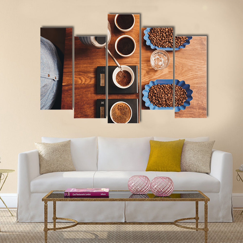 Overhead shot of a professional barista pouring hot water from a stainless steel kettle Multi Panel Canvas Wall Art