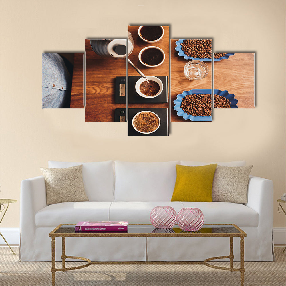 Overhead shot of a professional barista pouring hot water from a stainless steel kettle Multi Panel Canvas Wall Art