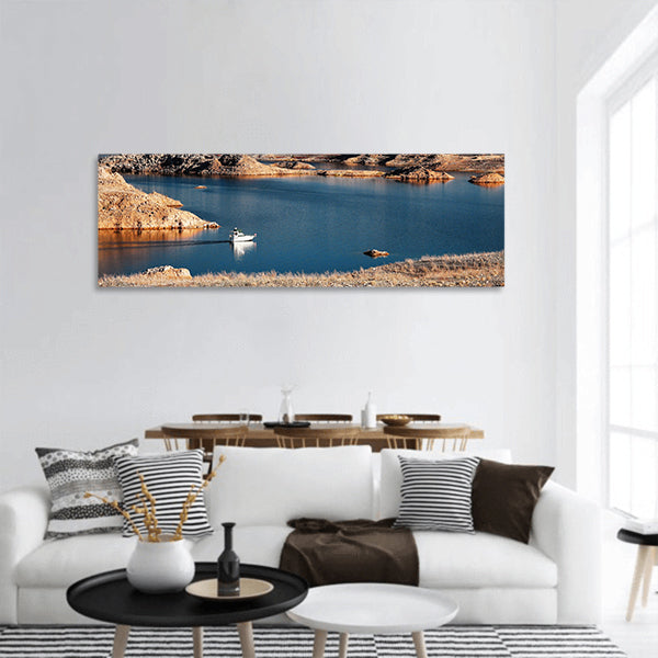 A white motorboat cruising through a channel in Lake Mead panoramic canvas wall art
