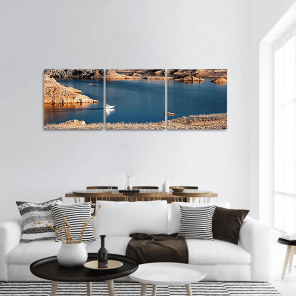 A white motorboat cruising through a channel in Lake Mead panoramic canvas wall art
