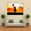 Silhouette of a medieval knight on horse carrying a flag Multi panel canvas wall art