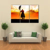 Silhouette of a medieval knight on horse carrying a flag Multi panel canvas wall art