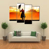 Silhouette of a medieval knight on horse carrying a flag Multi panel canvas wall art