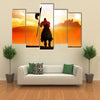 Silhouette of a medieval knight on horse carrying a flag Multi panel canvas wall art