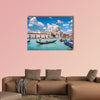 Beautiful view of traditional Gondolas on Canal Grande with historic wall art