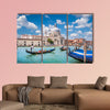 Beautiful view of traditional Gondolas on Canal Grande with historic wall art