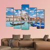 Beautiful view of traditional Gondolas on Canal Grande with historic wall art