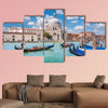 Beautiful view of traditional Gondolas on Canal Grande with historic wall art